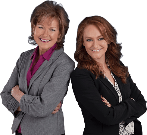An image of two confident women financial advisors smiling with arms crossed, representing trust and expertise in financial planning and fiduciary services.